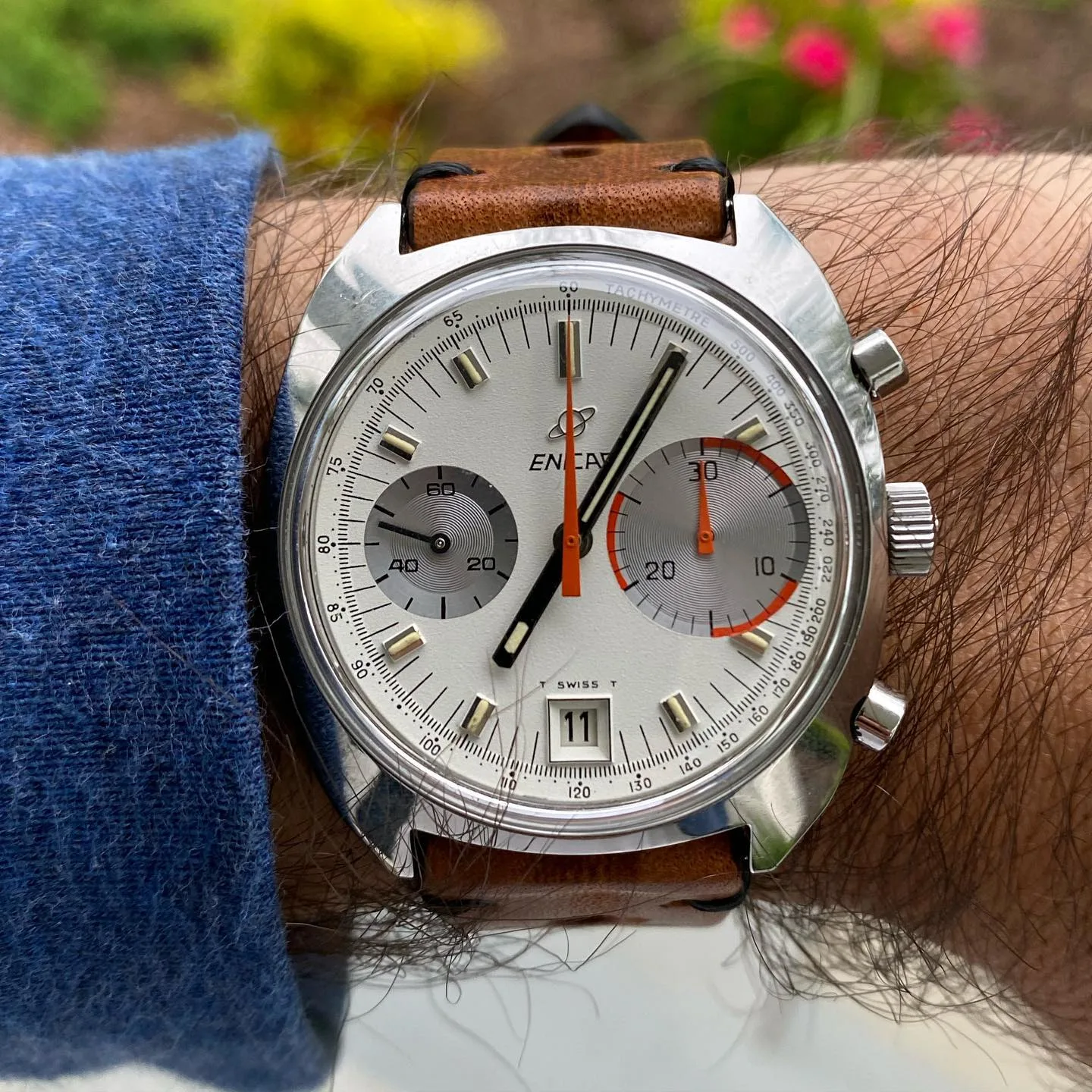 Big Eye with a white dial, grey left register and larger right-hand counter on a tan strap, on the wrist