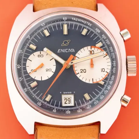 Big Eye chronograph with a blue dial, white registers and orange chronograph and register hands, against an orange background