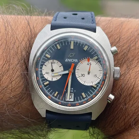 F45 chronograph with a navy dial, white registers and orange chronograph hand on a navy strap, on the wrist