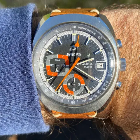Grapho-Matic with a grey dial, orange chronograph hand and orange-framed registers on a tan strap, on the wrist