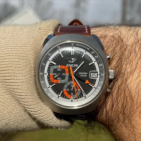 Grapho-Matic with a grey dial, orange hands and tachymetre scale on a brown strap, on the wrist