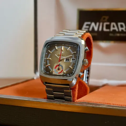 Mantagraph chronograph in a TV-shaped case with a gradient dial and red accents on a steel bracelet, in an Enicar box