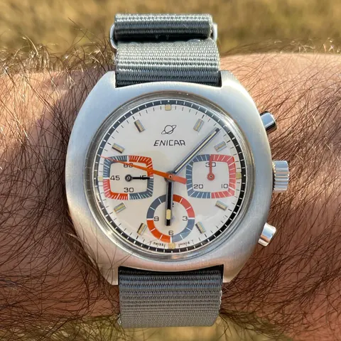 Ocean Pearl Valjoux 72 chronograph with a white dial and blue, red and orange registers on a grey NATO strap, on the wrist