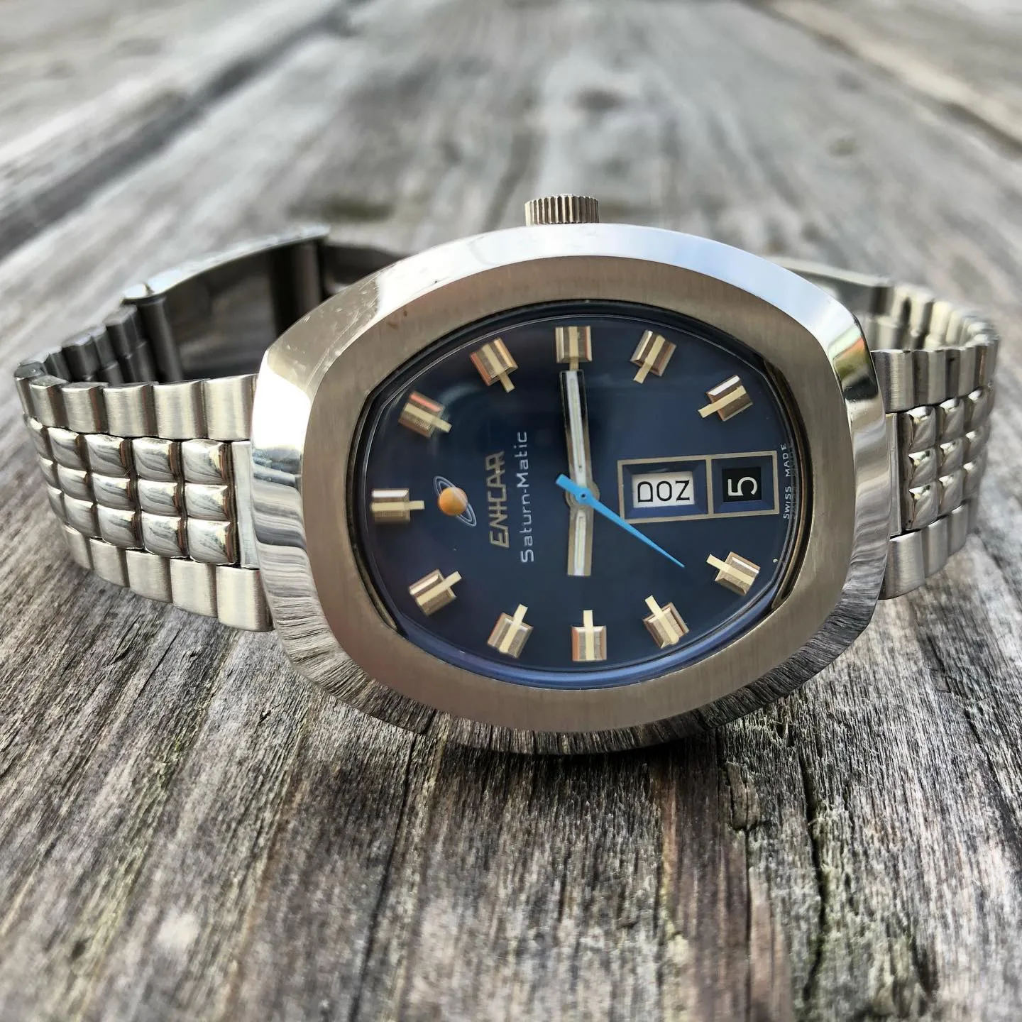 Saturn-Matic with a blue dial, blue seconds hand and day-date in a cushion case on a steel bracelet