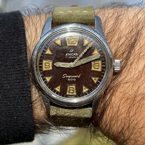 Seapearl 600 with a dial turning cranberry brown on an olive strap, on the wrist