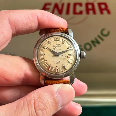 Seapearl with a cream dial and dauphine hands in a turtle case, held in the hand