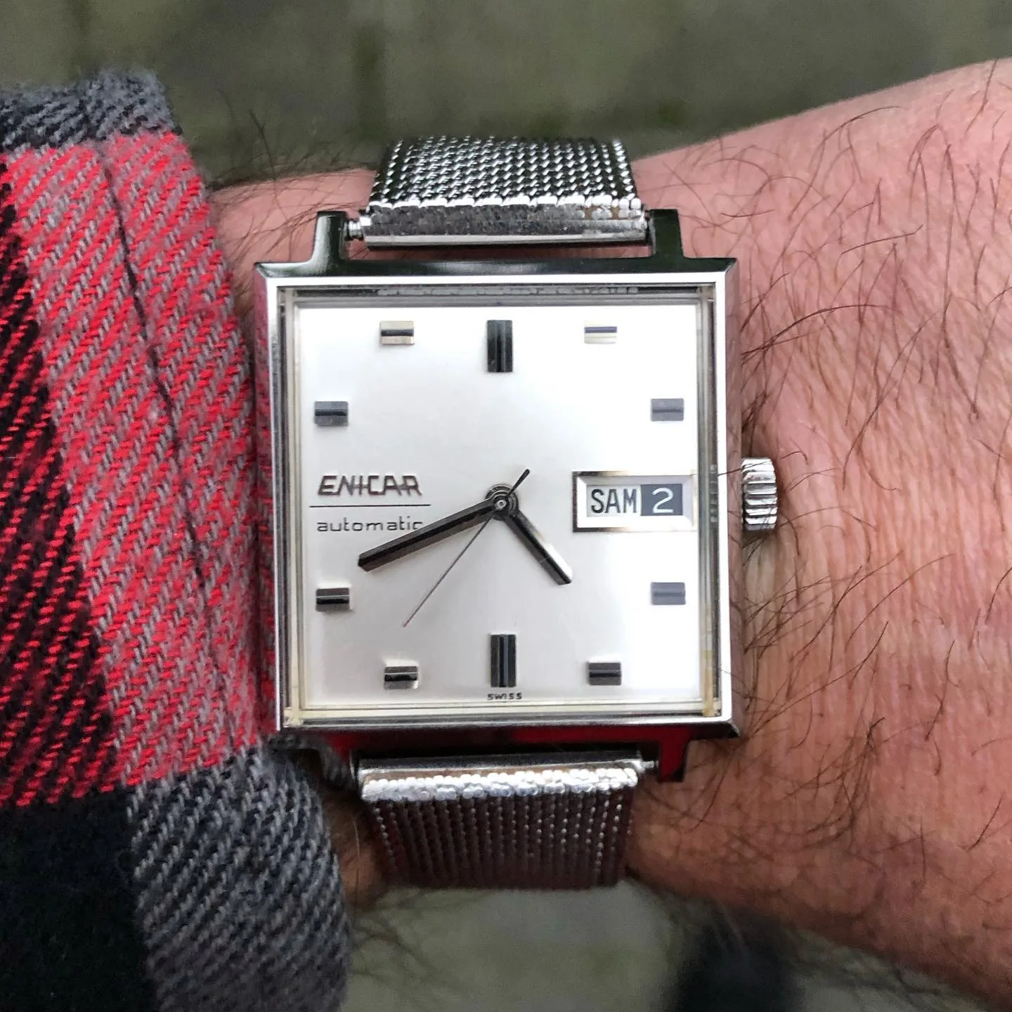 Square Enicar automatic with a silver dial and day-date on a mesh bracelet, on the wrist