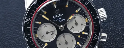 Close-up of an Aqua Graph black dial with grey registers and its paddle hands