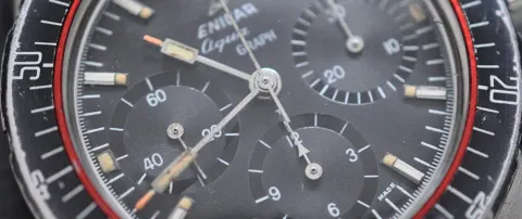 Close-up of an all-black Aqua Graph dial showing the register hands