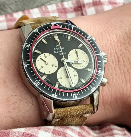 Aqua Graph with a black dial, cream registers and baton hands on a tan suede strap