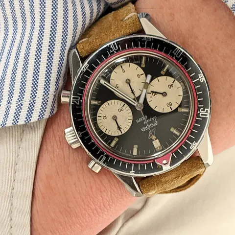 Aqua Graph with a black dial and cream registers on a tan suede strap, on the wrist