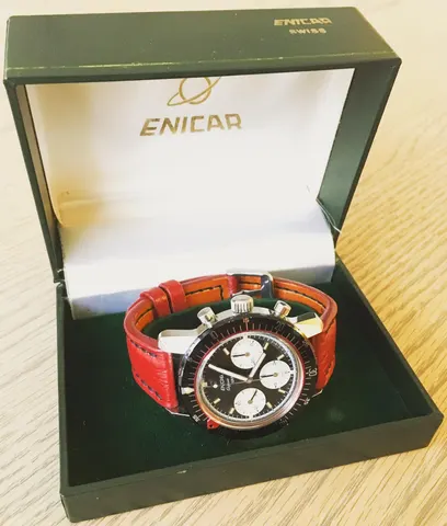 Aqua Graph with a racing dial on a red strap in an open green Enicar box