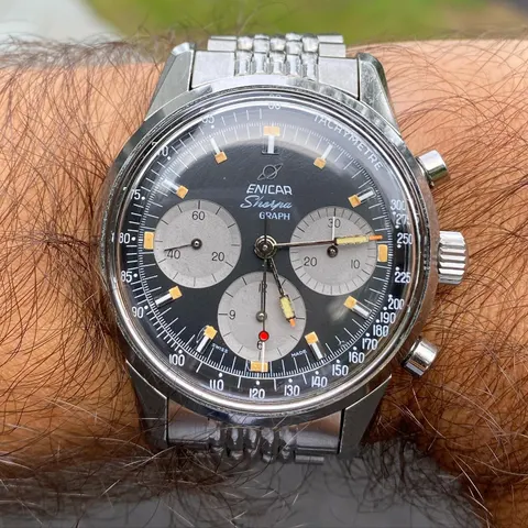 Sherpa Graph with a black dial, grey registers and red-dot chronograph hand on a steel bracelet, on the wrist