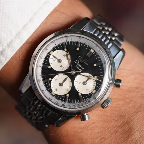 Sherpa Graph MkI with a black dial and cream registers on a beads-of-rice bracelet, on the wrist