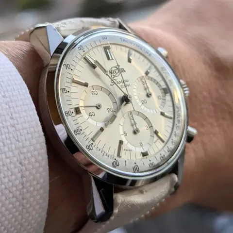 Sherpa Graph with a white dial, white registers and Tachymetre ring on a white strap, on the wrist