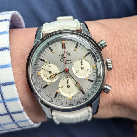 Sherpa Graph with a grey dial, cream registers and red chronograph hand on a white strap, on the wrist