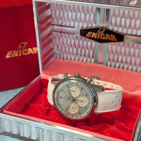 The same Sherpa Graph inside its open Enicar box with a red interior