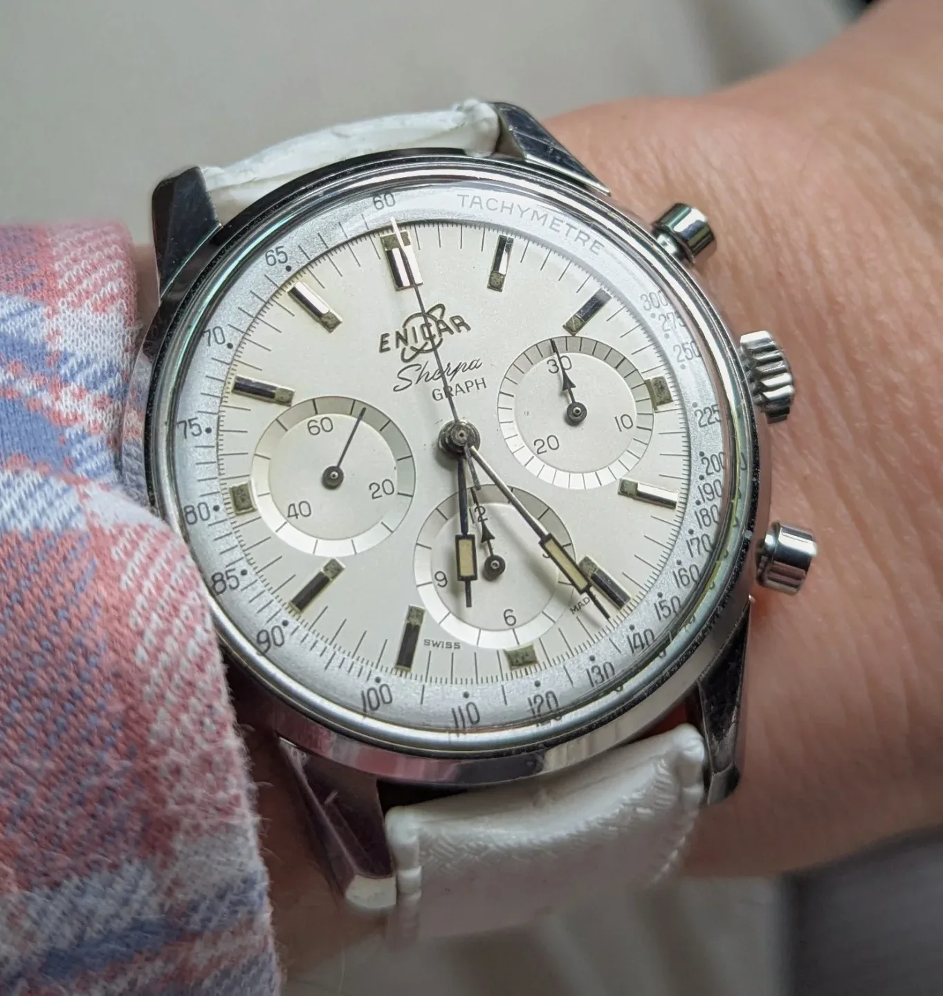 Sherpa Graph with a white dial, silver subdials and outer tachymeter scale on a white strap, on the wrist