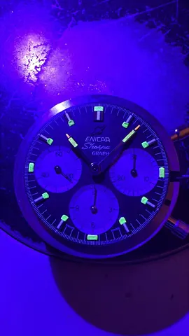 The same Sherpa Graph under ultraviolet light, showing the glowing lume on the markers and hands
