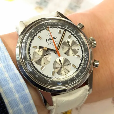Sherpa Graph with a white dial, silver registers and orange triangle chronograph hand on a white strap
