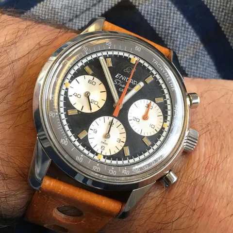 Sherpa Graph with a black dial, white registers and orange chronograph hand on a tan strap, on the wrist