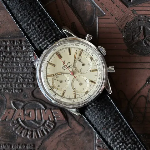 Sherpa Graph with a cream dial on a black rubber strap, lying on a printing plate