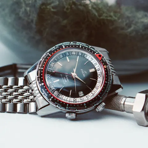 Sherpa Guide MkI with a black dial and world-city bezel on a steel bracelet