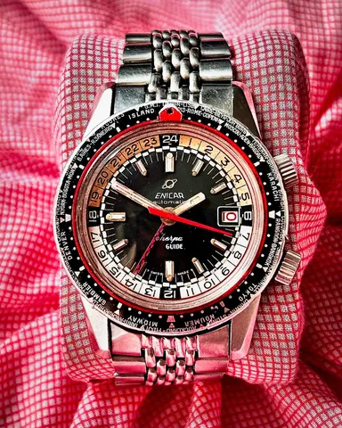 Sherpa Guide automatic with a black dial, rally-style red 24-hour hand, red seconds hand, red pointer and world-city outer bezel on a steel bracelet