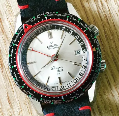 Sherpa Guide with a silver dial marked 33, world-city outer bezel and red GMT hand, on a black strap