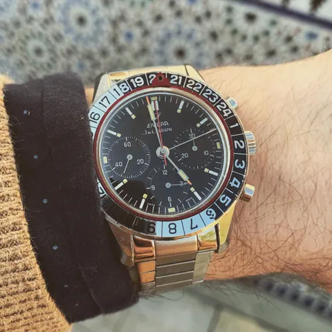 Jet Graph MkII with an all-black dial and black and pale blue 24-hour bezel on a steel bracelet, on the wrist