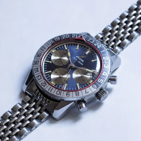 Blue-dial Jet Graph seen at an angle, showing the 24-hour bezel and pushers