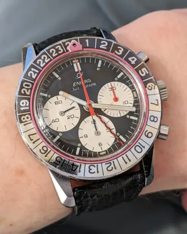 Jet Graph with a black dial, white registers and red counter hand on a black strap