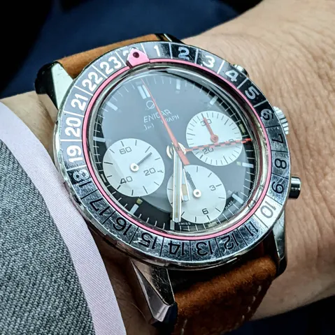 Close view of a Jet Graph with a black dial, white registers and checkered GMT hand on a brown suede strap