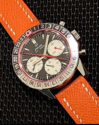 Jet Graph with a black dial, white registers, red minute-counter hand, checkered GMT hand and black and silver 24-hour bezel on an orange strap