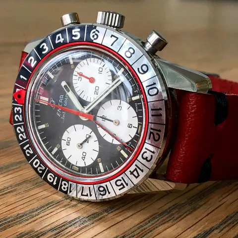 Jet Graph with a black dial, white registers, red counter hand and checkered GMT hand on a red strap