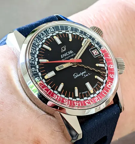 Sherpa Jet with a black dial, checkered GMT hand and red and blue inner bezel on a blue strap
