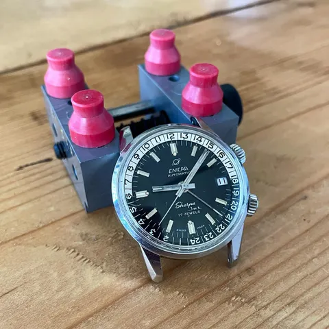 Sherpa Jet with a black dial marked 17 Jewels and a black and white inner bezel, on a case holder