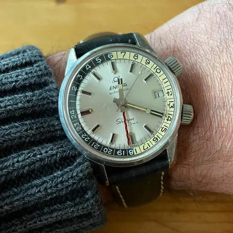 Sherpa Jet with a silver dial, black and cream inner 24-hour bezel and red and black checkered GMT hand, on the wrist