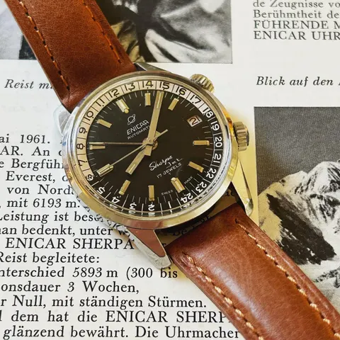 Sherpa Jet with a black dial marked 17 Jewels on a brown leather strap, lying on a 1961 Saturn magazine