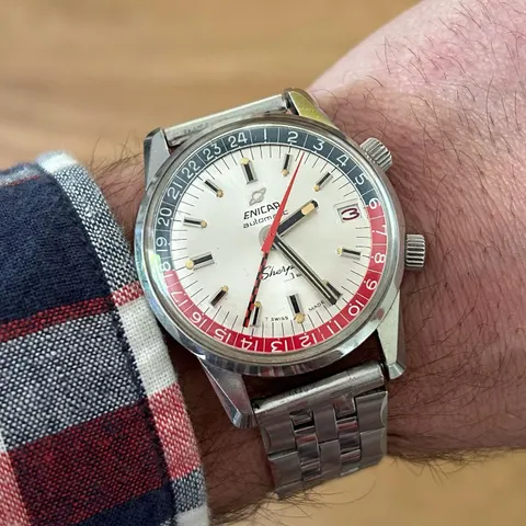 Sherpa Jet with a silver dial, red and blue inner bezel and red date, on a steel bracelet