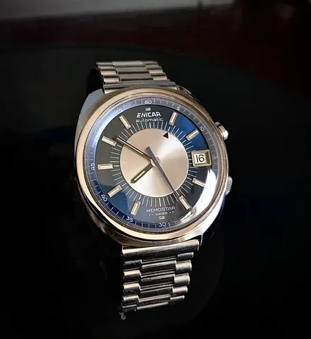 Enicar Memostar alarm watch with a dark blue and silver dial and a date window, on a steel bracelet