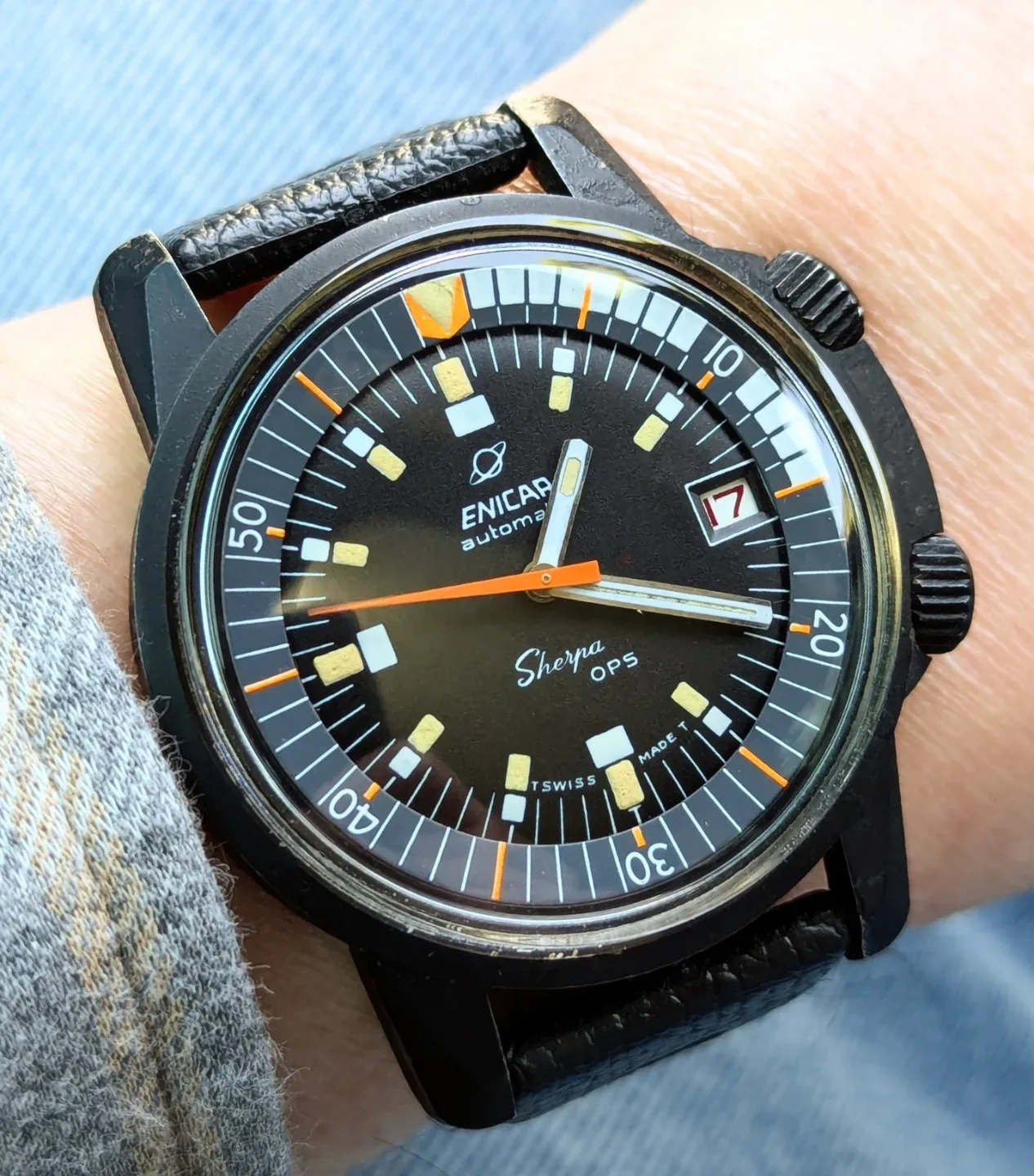 Sherpa OPS with a black case and dial, orange seconds hand and inner bezel, on a black strap