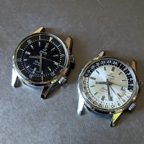 A Sherpa Super-Dive with a black dial next to a Sherpa Super-Jet with a silver dial, both without straps