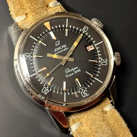 Sherpa Super-Dive with a black dial and black inner bezel on a tan suede strap