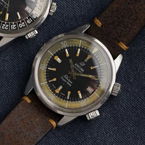 Sherpa Super-Dive with a black dial and patinated inner bezel on a brown leather strap