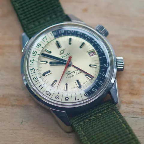 Sherpa Super-Jet with a silver dial and red and black checkered GMT hand on a green canvas strap