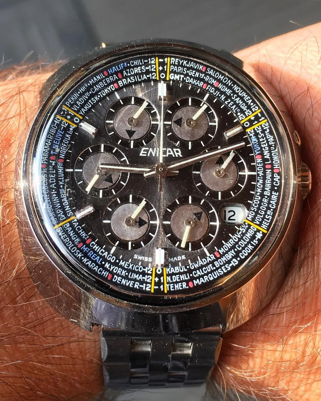 Sherpa World Time with a grey dial, six small time-zone dials and a ring of city names, on the wrist