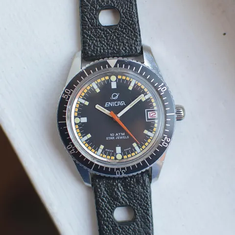 Enicar Star Jewels 10 ATM diver with a black dial, orange seconds hand and black outer bezel on a black rally strap