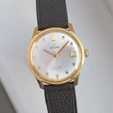 Enicar Star Jewels automatic with a silver dial, date and gold-coloured case on a dark brown leather strap