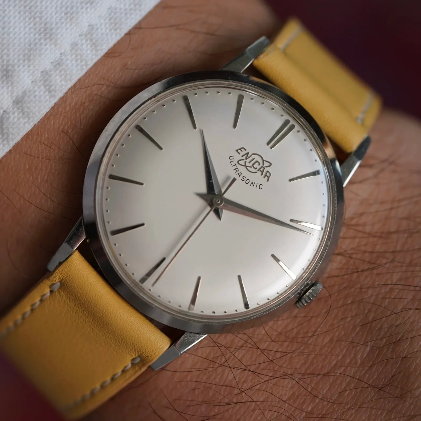 Ultrasonic 1000/24 with a white dial, baton markers and centre seconds on a yellow strap, on the wrist